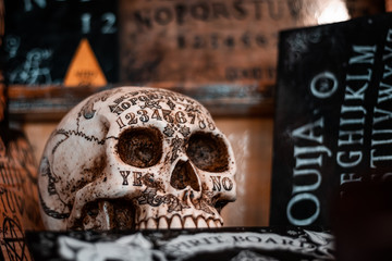 Talking board and planchette, also known as Ouija board, used for communicating with the dead and other spirits or deamons. Halloween background, hand made horror elements for Tv and cinema movies. 
