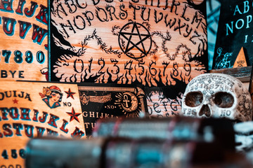 Talking board and planchette, also known as Ouija board, used for communicating with the dead and other spirits or deamons. Halloween background, hand made horror elements for Tv and cinema movies. 