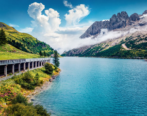 Fototapeta premium Splendid morning view of Fedaia lake. Colorful summer scene of Dolomiti Alps, Gran Poz location, Trentino-Alto Adige/Sudtirol region, Italy, Europe. Beauty of nature concept background.