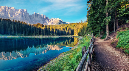 Attractive summer view of Carezza (Karersee) lake. Awesome morning scene of Dolomiti Alps, Province of Bolzano, South Tyrol, Italy, Europe. Beauty of nature concept background.