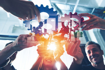 Business team connect pieces of gears. Teamwork, partnership and integration concept. double...