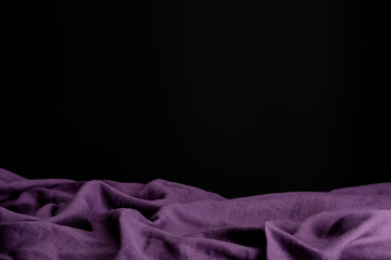crumpled purple cloth isolated on black with copy space