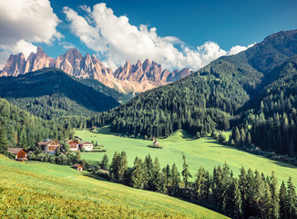 Splendid morning view of St. Magdalena village. Sunny summer scene of Funes Valley (Villnob) with Odle Group mountains on background, Dolomiti Alps, Bolzano, South Tyrol, Italy.