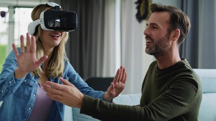 Modern couple using virtual reality simulator