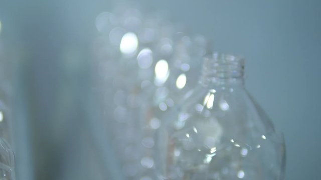 Empty plastic bottles move through the factory line