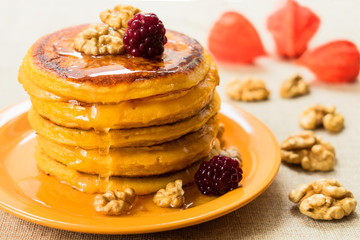  Pumpkin pancakes with honey and nuts, berries. End of seasonal (autumn) breakfast.