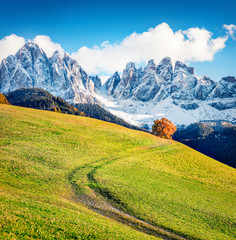 Fototapeta na wymiar Impressive view of Santa Magdalena village hills in front of the Geisler or Odle Dolomites Group. Colorful autumn scene of Dolomite Alps, Italy, Europe. Beauty of countryside concept background.