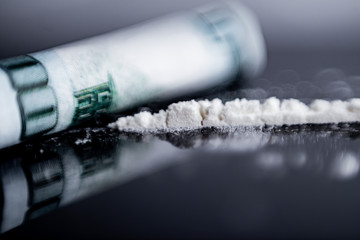 white powder (heroin, cocaine, narcotic) scattered in the form of a track, a bill folded into a...