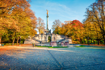 Splendid autumn view of Angel of Peace (Friedensengel) monument, park statue of a golden angel on a...