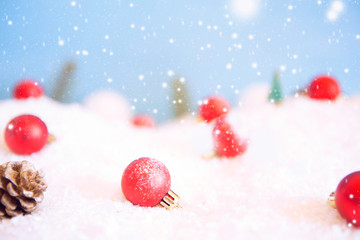 Fototapeta na wymiar Red Christmas balls on snow. Macro shot