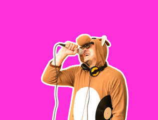 Man in cosplay costume of a cow singing karaoke isolated on purple background. Guy in the funny...