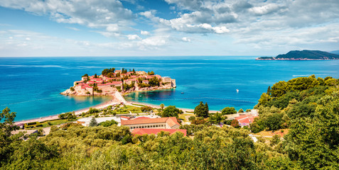 Naklejka premium Aerial summer cityscape of Sveti Stefan town. Panoramic morning seascape of Adriatic sea, Montenegro, Europe. Beautiful world of Mediterranean countries. Traveling concept background.