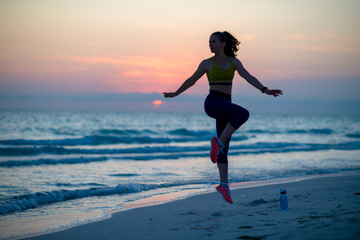 Fototapeta na wymiar fitness sports woman on seashore in evening training