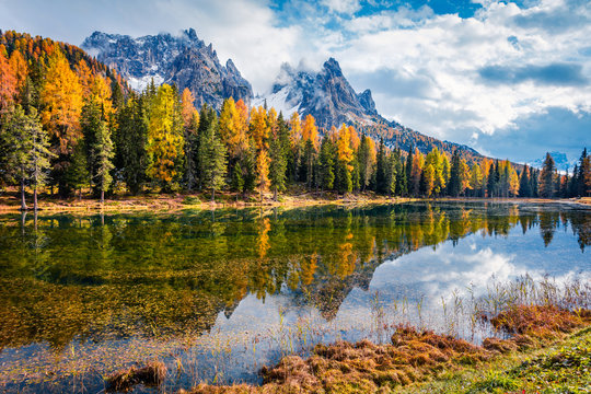 Fantastic autumn scene of Antorno lake. Picturesque morning view of Dolomite Alps, Province of Belluno, Italy, Europe. Beauty of nature concept background.