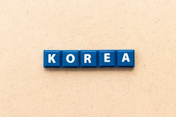Tile letter in word Korea on wood background