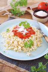 Pearl barley with tomato sauce and grated parmesan cheese