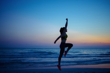 healthy sports woman on seashore in evening training