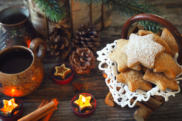 New Year composition with burning candle: coffee and Christmas cinnamon cookies