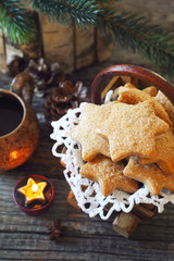New Year composition with burning candle: cup of coffee and Christmas cinnamon cookies