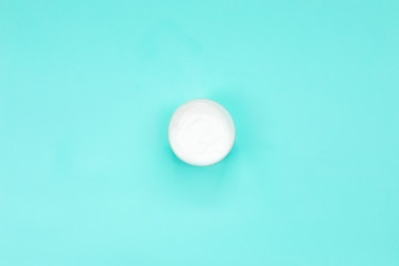 Cosmetic cream or body cream container on blue background