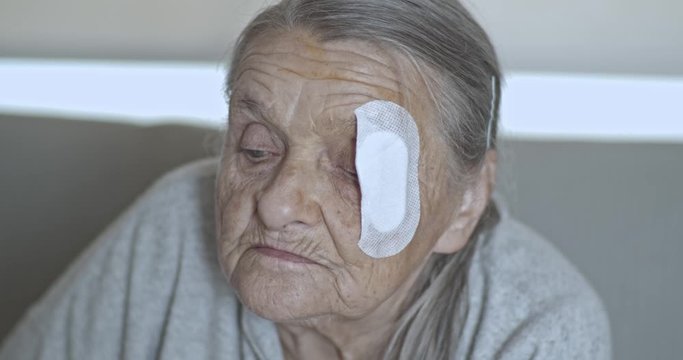 Old Lady with injured eye Cataract, Glaucoma close up