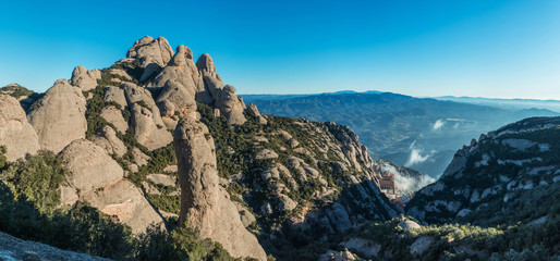 Aerial and panoramic view of the Monastery of Montserrat between the rock formations of the Montserrat mountain