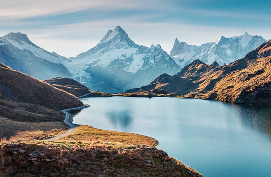 Gorgeous evening panorama of Bachalp lake / Bachalpsee, Switzerland. Exotic autumn sunrise in Swiss alps, Grindelwald, Bernese Oberland, Europe. Beauty of nature concept background.