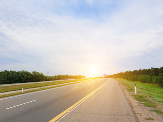 empty rural road lit by sunlight