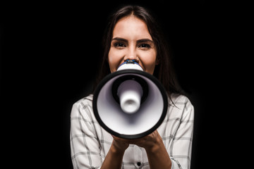 cheerful woman holding megaphone isolated on black