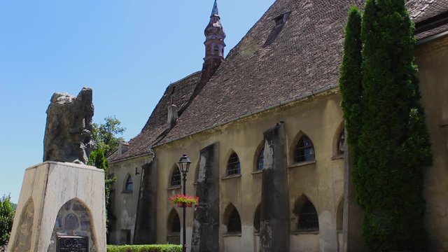 Gothic Church of the Dominican Monastery , Sighisoara, Transylvania, Romania, in summer day. The statue that is seen depicts Vlad Tepes aka Count Dracula, born in this citadel. HD Static Video