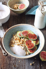 Healthy breakfast: oatmeal, yogurt, ripe figs, walnuts and milk