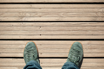 Green suede shoes on wooden floor - Powered by Adobe