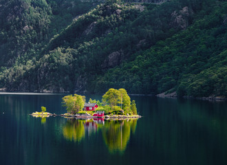 Beautiful summer view of small island with typical Norwegian building on Lovrafjorden flord, North...