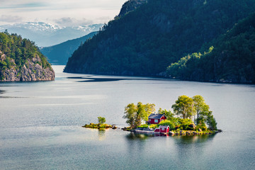 Magnificent summer view with small island with typical Norwegian building on Lovrafjorden flord, North sea. Colorful morning view in Norway. Beauty of nature concept background. - obrazy, fototapety, plakaty