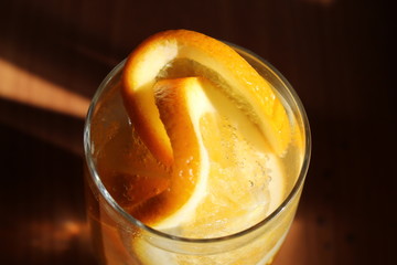 orange cut into slices in a glass of sparkling water.