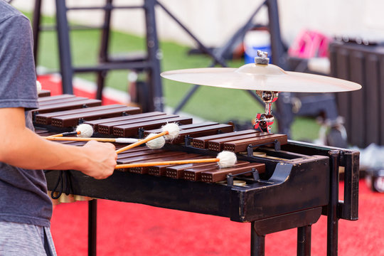 sideline percussionist performing at an outdoors rehearsal