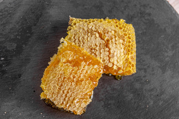 Slide sweet honeycombs on a stone board, organic product
