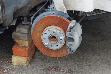 old disassembled car with a brake shoe and a crumpled wing