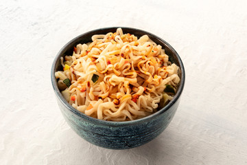 Instant soba noodles with carrot, scallions, and a sauce, a close-up shot