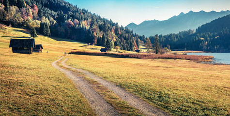 Panoramic morning view of Wagenbruchsee lake with Kaltwasserkar Spitze mountain range on background. Stunning autumn scene of Bavarian Alps, Germany, Europe. Beauty of nature concept background.