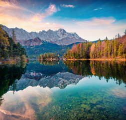 Colorful morning scene of Eibsee lake with Zugspitze mountain range on background. Amazing autumn view of Bavarian Alps, Germany, Europe. Beauty of nature concept background.