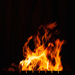 Fototapeta na wymiar Fire flames. Bonfire in the barbecue, fireplace and a hot home.