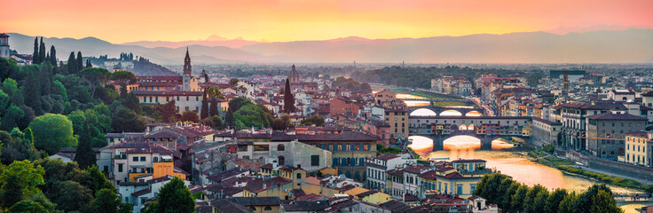 Panoramic evening cityscape of Florence, Italy, Europe. Beautiful medieval arched river bridges over Arno river.Traveling concept background. - obrazy, fototapety, plakaty