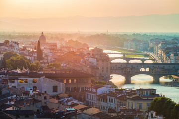 Colorful evening cityscape of Florence, Italy, Europe.  Beautiful medieval arched river bridge with Roman origins - Ponte Vecchio over Arno river.Traveling concept background.