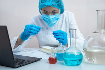 Laborant woman making laboratory analysis, sitting in office