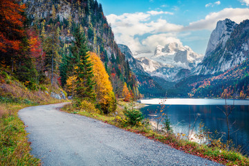 Amazing autumn scene of Vorderer / Gosausee lake with Dachstein glacieron background. Breathtaking morning view of Austrian Alps, Upper Austria, Europe. Traveling concept background.