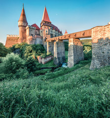 Awesome morning view of Hunyad Castle / Corvin's Castle. Stunning summer cityscape of Hunedoara, Transylvania, Romania, Europe. Romanian castle landmarks. Traveling concept background.