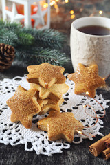 Fototapeta na wymiar Christmas cinnamon cookies, cup of tea and New Year's decoration