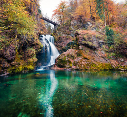 Fototapeta na wymiar Amazing view of huge waterfall in Vintgar Gorge Canyon. Nice autumn scene of Triglav National Park, Julian Alps, Slovenia, Europe. Beauty of nature concept background..