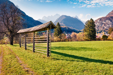 Exciting autumn view of Triglav mountain range and Gozd Martuljek village. Picturesque morning scene of Julian Alps, Slovenia, Europe. Beauty of nature concept background.